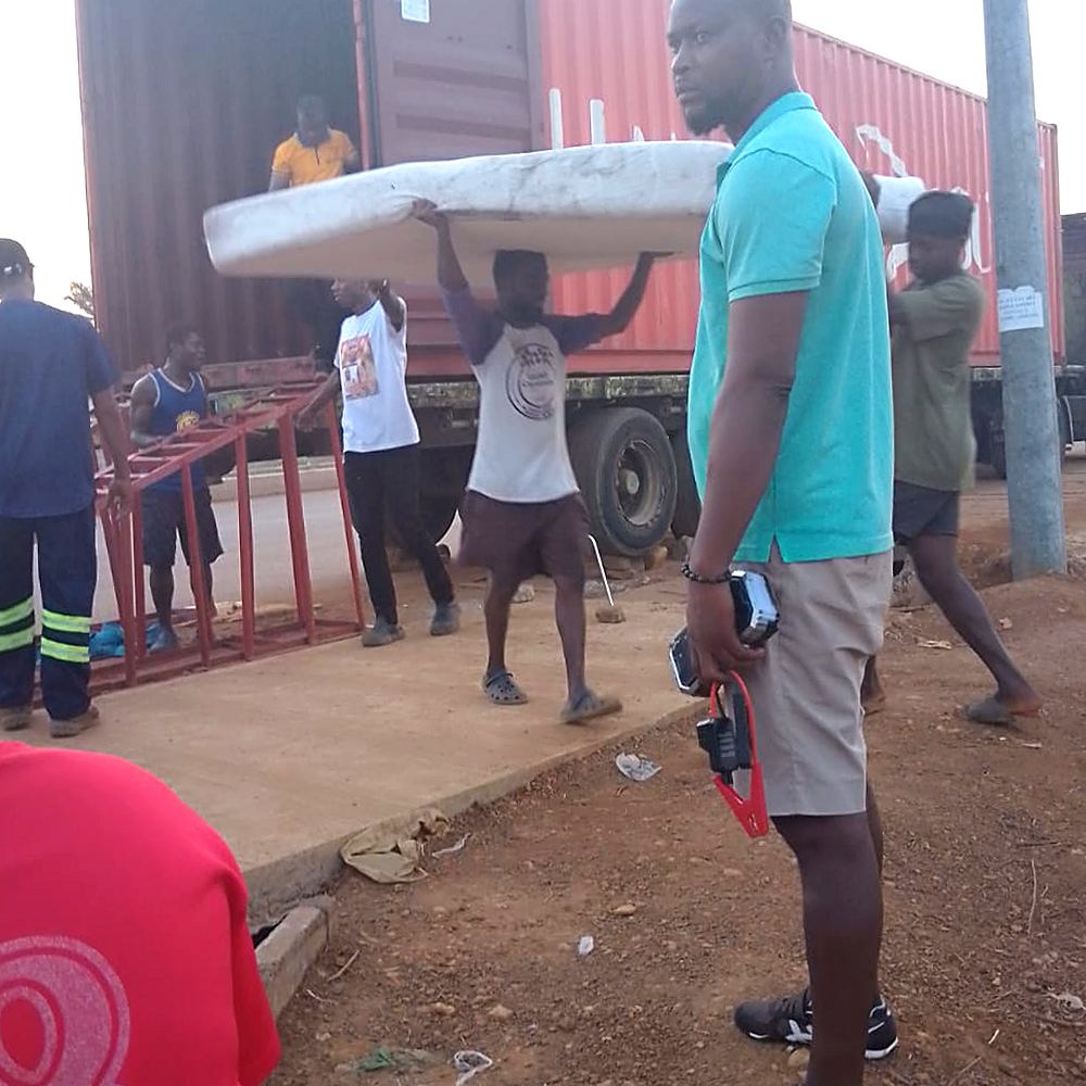Volunteers carry a mattress overhead